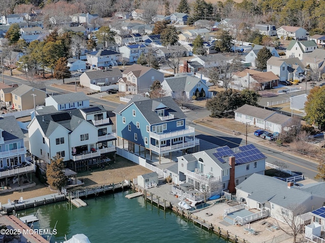 birds eye view of property with a water view and a residential view