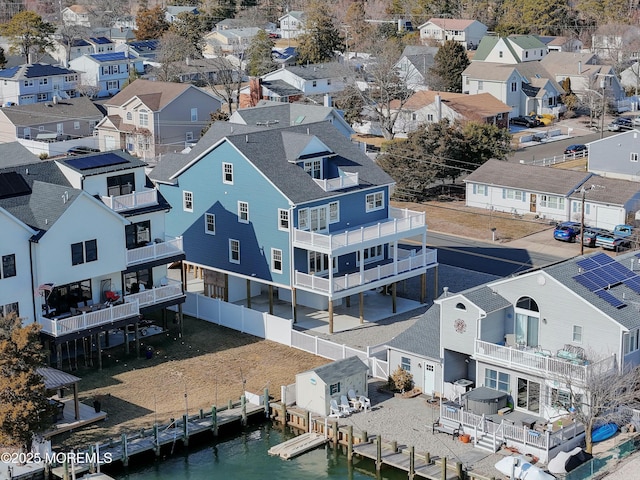 drone / aerial view featuring a residential view and a water view