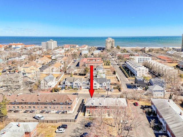 birds eye view of property featuring a city view and a water view