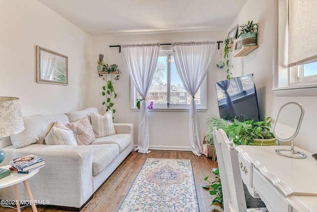 living room featuring light wood finished floors and baseboards