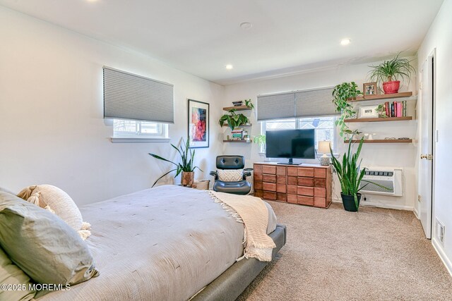 bedroom with recessed lighting, heating unit, and light colored carpet