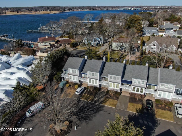 drone / aerial view with a water view and a residential view