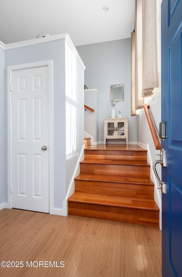 stairs with baseboards and wood finished floors