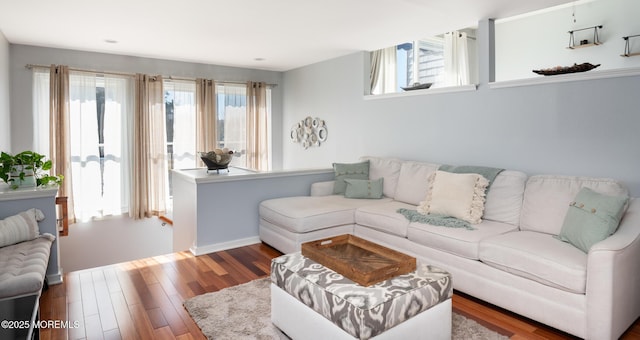 living room with wood finished floors and baseboards