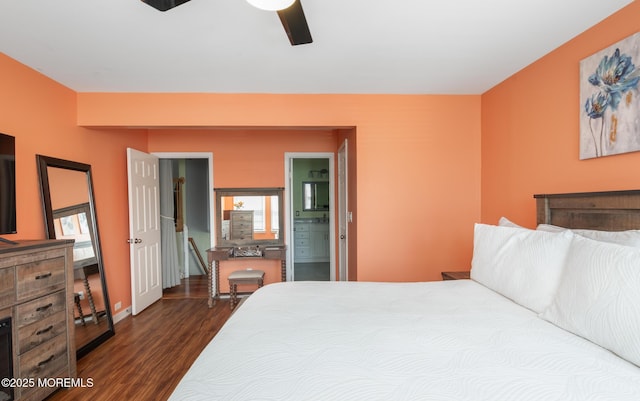 bedroom featuring dark wood-style flooring, ceiling fan, and ensuite bath