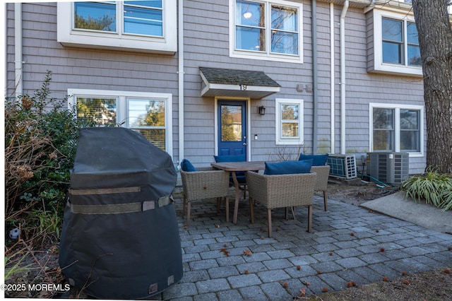 view of patio featuring outdoor dining area, central AC, and area for grilling