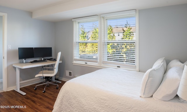 bedroom featuring dark wood-style flooring and baseboards