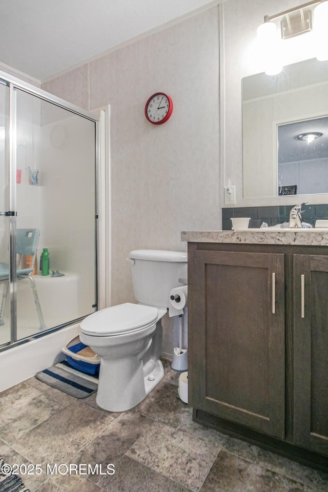 full bathroom featuring combined bath / shower with glass door, vanity, and toilet