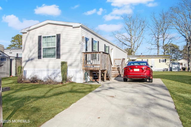 view of front of house featuring a deck and a front lawn