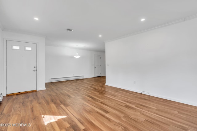 unfurnished living room with visible vents, baseboards, ornamental molding, baseboard heating, and light wood-style flooring