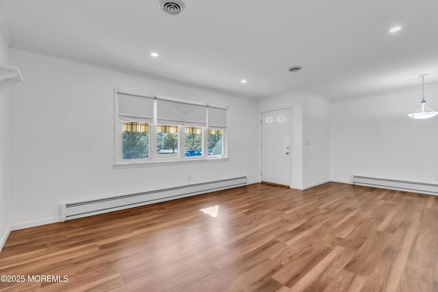 unfurnished room with crown molding, visible vents, and a baseboard radiator