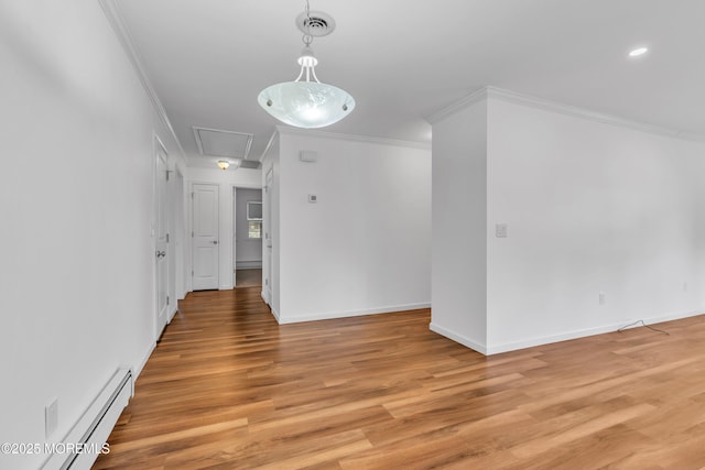 interior space with crown molding, attic access, light wood finished floors, and a baseboard radiator