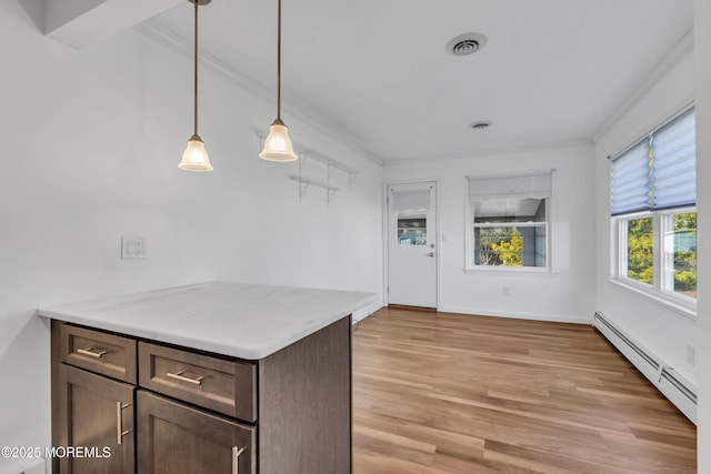 kitchen featuring visible vents, a baseboard heating unit, dark brown cabinetry, light wood-type flooring, and ornamental molding