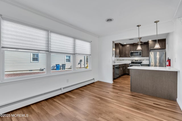 kitchen with visible vents, a baseboard heating unit, dark brown cabinetry, appliances with stainless steel finishes, and light countertops