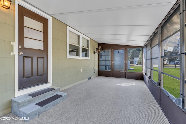 unfurnished sunroom featuring lofted ceiling