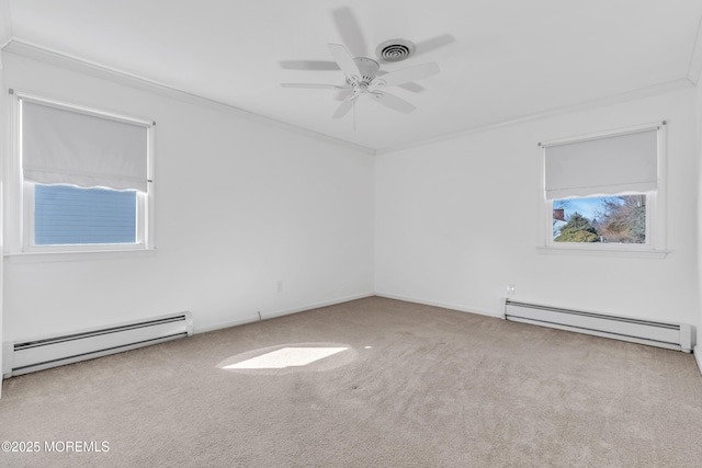 carpeted empty room featuring a baseboard heating unit, a wealth of natural light, and ornamental molding