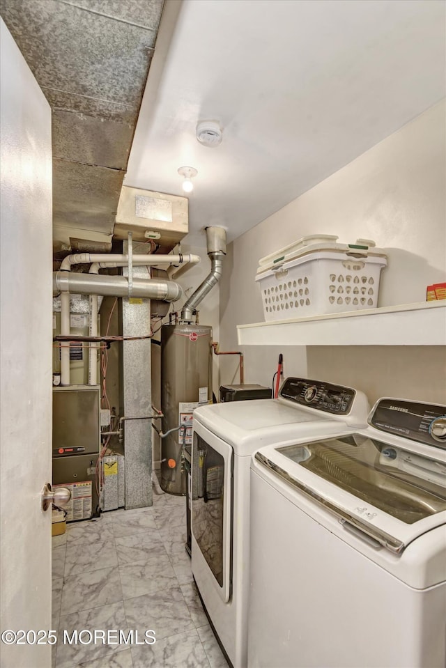 laundry room featuring laundry area, water heater, washer and clothes dryer, and marble finish floor