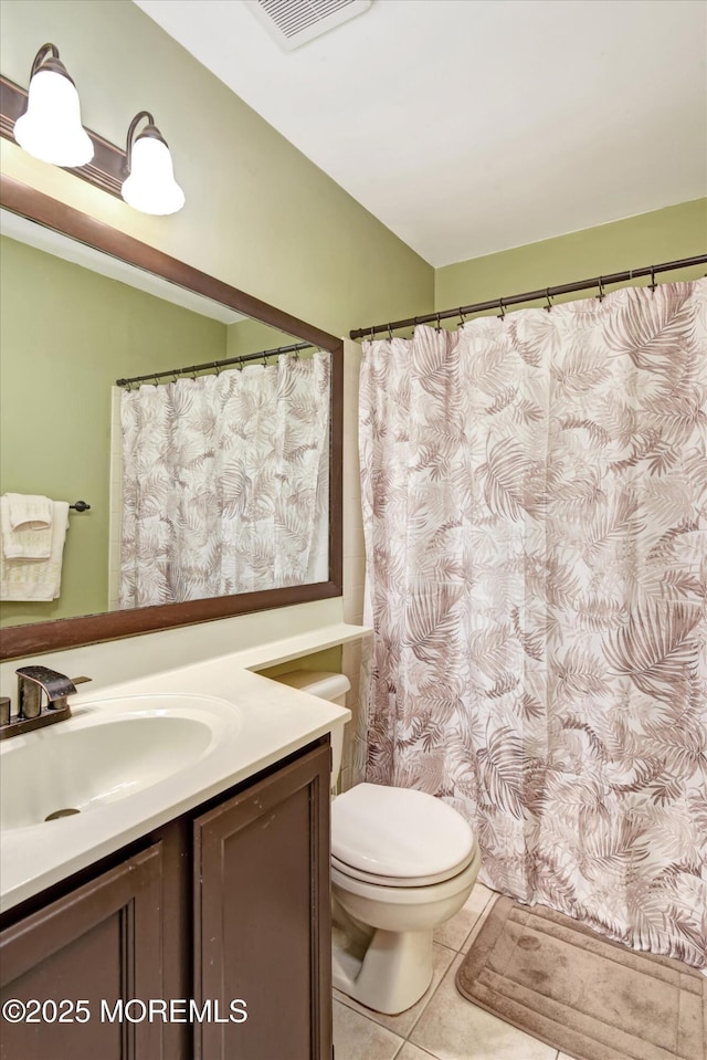 bathroom with toilet, tile patterned floors, visible vents, and vanity