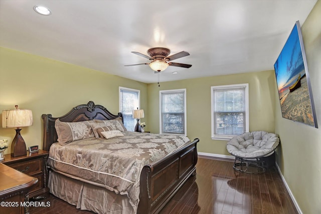 bedroom with ceiling fan, baseboards, and dark wood finished floors