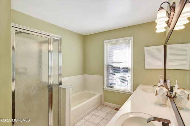 bathroom featuring a garden tub, double vanity, a stall shower, a sink, and tile patterned floors