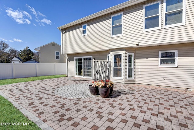 back of house with a patio and fence