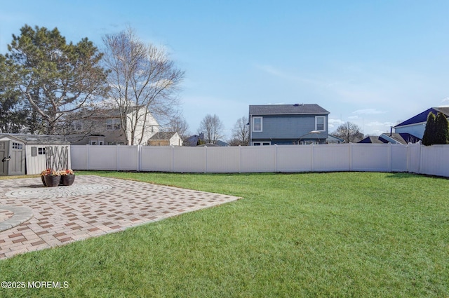 view of yard with an outbuilding, a fenced backyard, a patio, and a storage shed