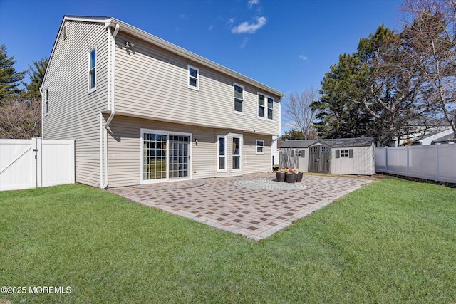 rear view of property with a fenced backyard, a patio, a storage shed, and a lawn