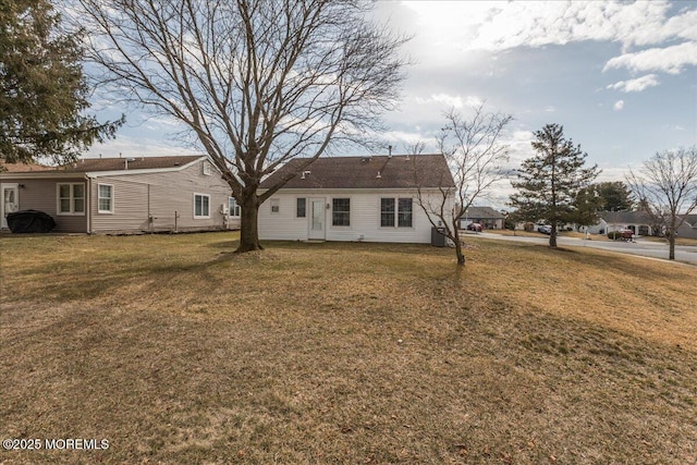 rear view of property with a lawn