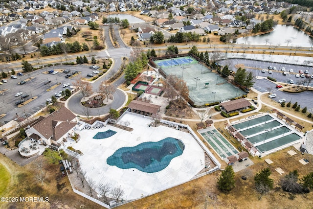 drone / aerial view with a water view and a residential view