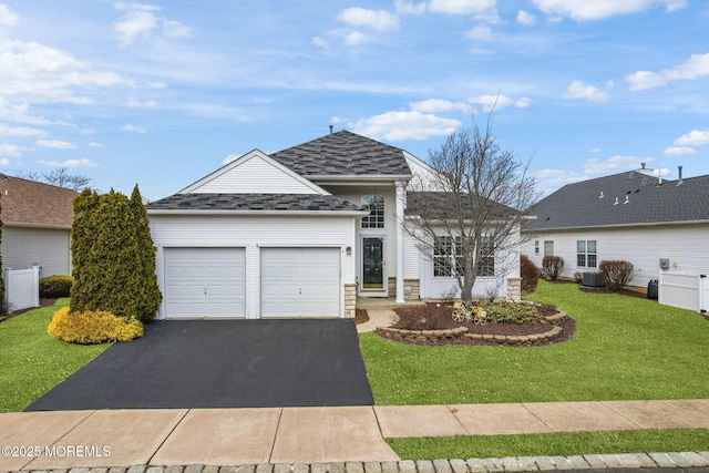 ranch-style home featuring roof with shingles, central AC unit, stone siding, driveway, and a front lawn