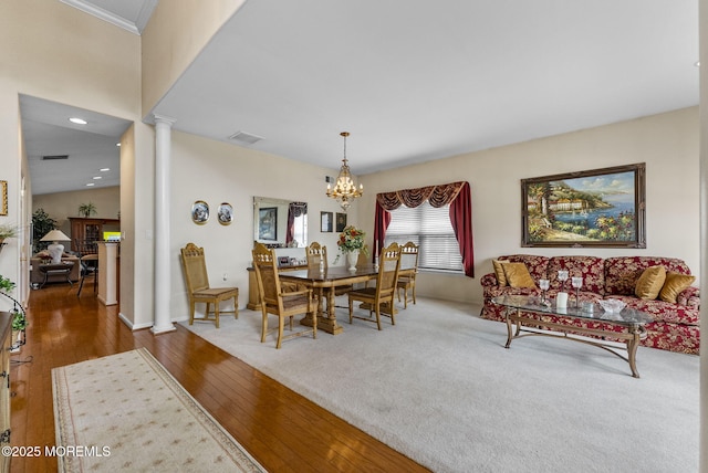 dining area featuring a notable chandelier, decorative columns, recessed lighting, wood-type flooring, and visible vents