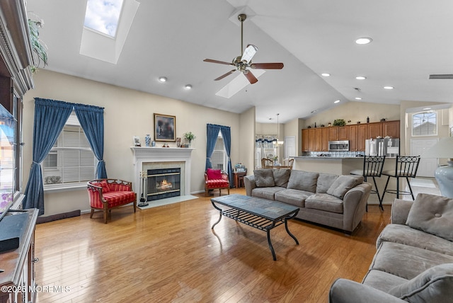 living room with light wood-style floors, visible vents, and plenty of natural light