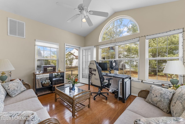 living area featuring lofted ceiling, visible vents, ceiling fan, and wood finished floors