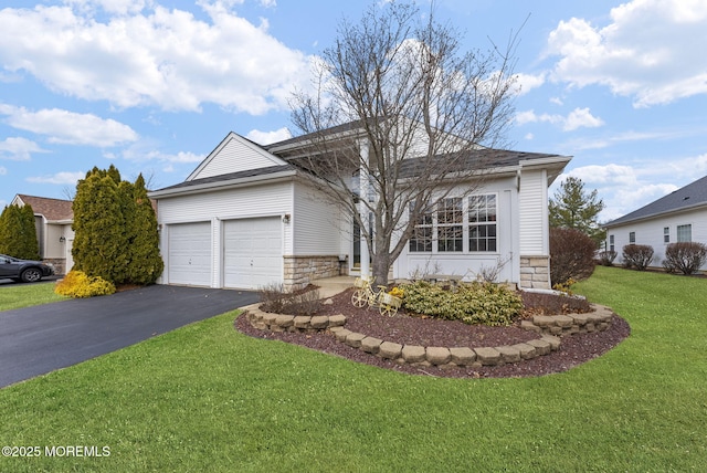 ranch-style house featuring driveway, stone siding, an attached garage, and a front yard