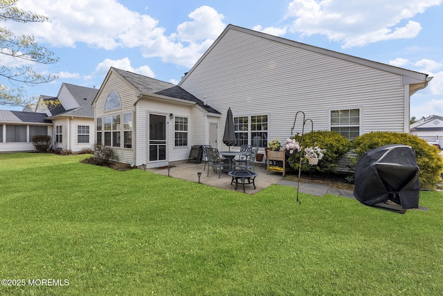 rear view of property with a patio and a yard