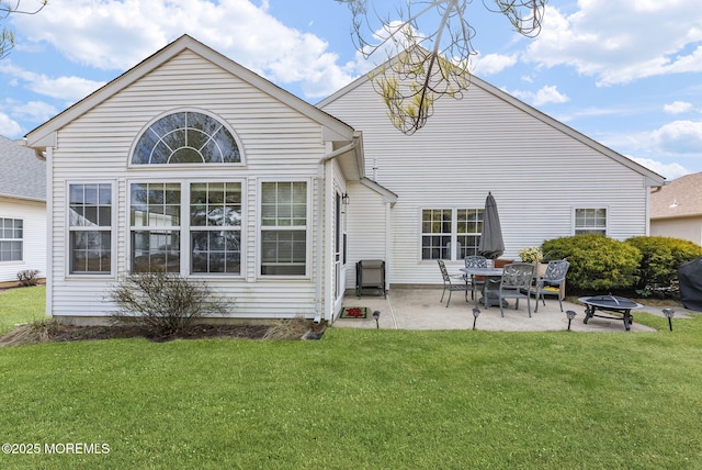 back of property with a patio area and a yard