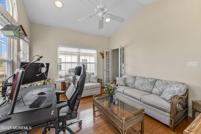 office featuring high vaulted ceiling, hardwood / wood-style floors, and a ceiling fan