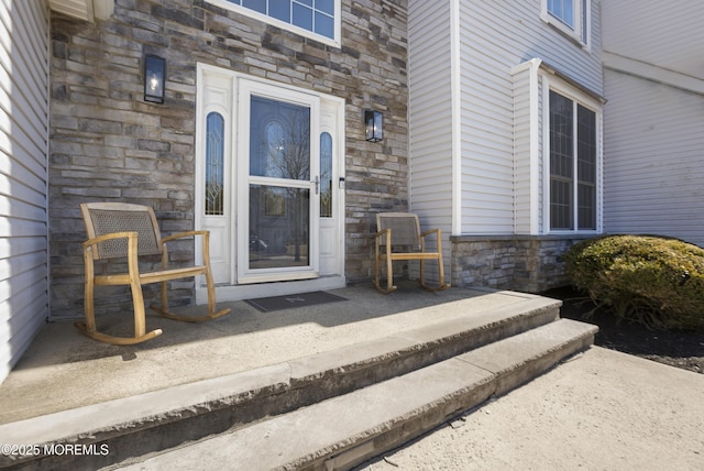 entrance to property featuring stone siding