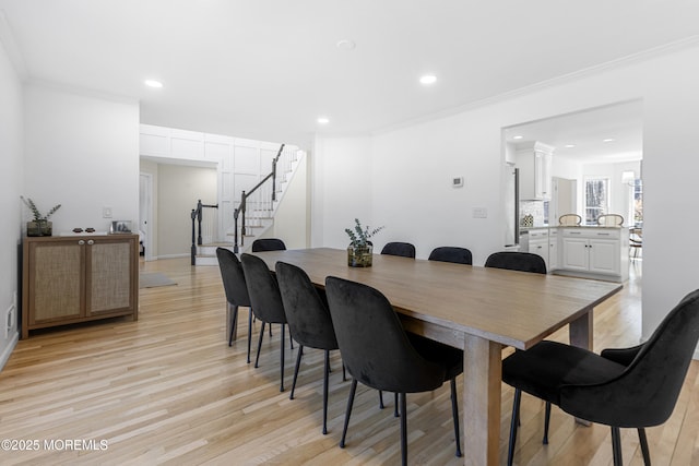 dining space featuring light wood-style flooring, stairway, crown molding, and recessed lighting