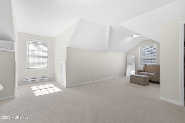 sitting room with a baseboard heating unit, carpet floors, an AC wall unit, and plenty of natural light