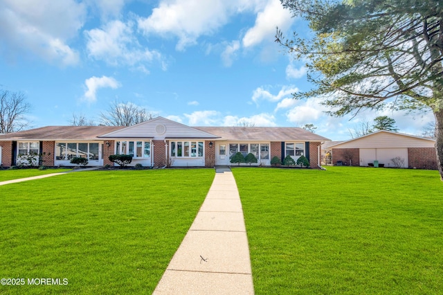 ranch-style house featuring brick siding and a front yard