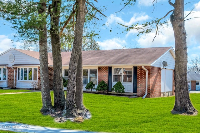 ranch-style home with brick siding and a front lawn