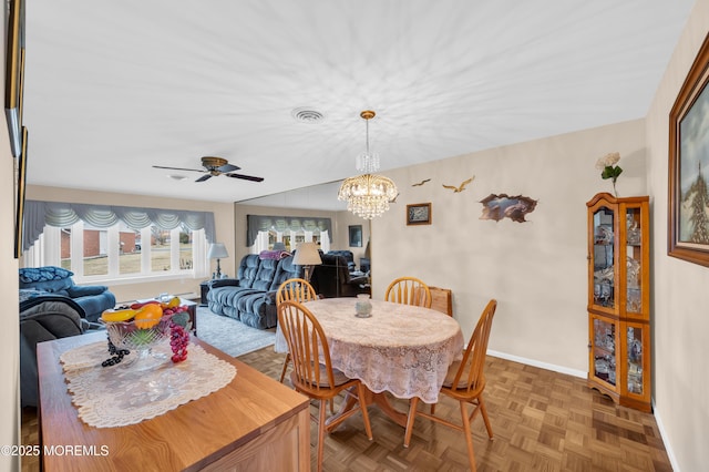 dining room with visible vents, baseboards, and ceiling fan with notable chandelier