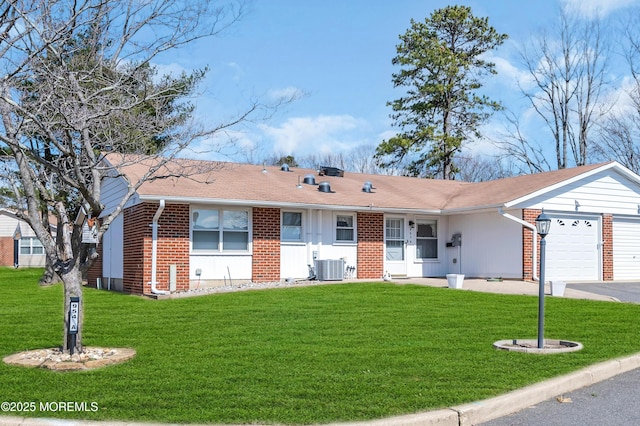 single story home with central AC unit, a garage, brick siding, driveway, and a front lawn