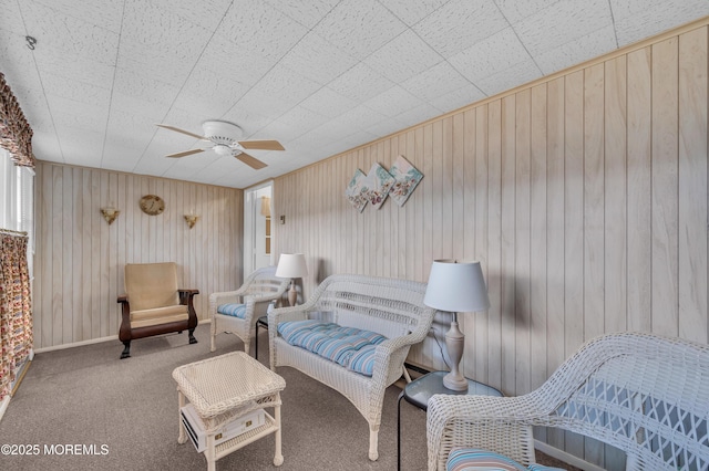 sitting room with carpet flooring, ceiling fan, and baseboards