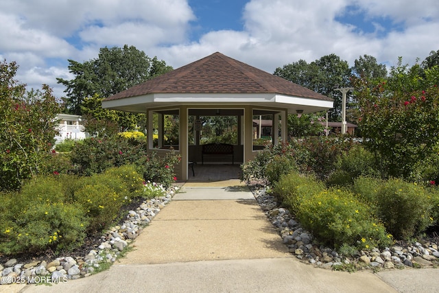 doorway to property featuring a shingled roof