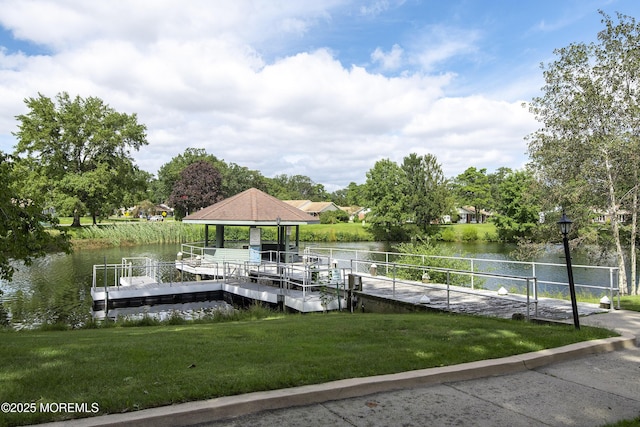 view of dock with a water view and a yard