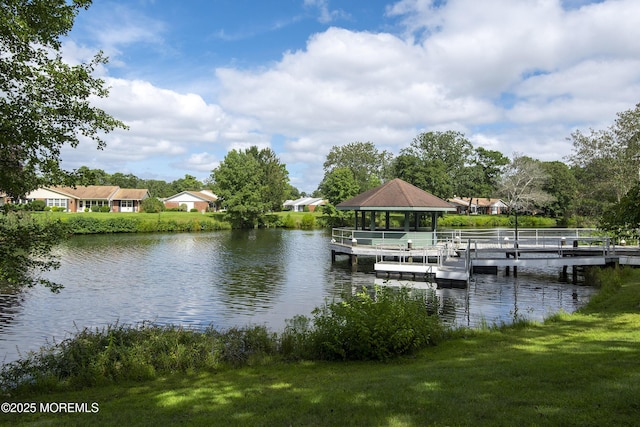 dock area featuring a yard, a water view, and a gazebo