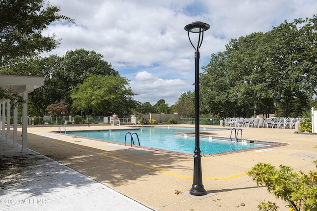 community pool featuring fence