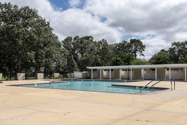 pool featuring a patio area and fence